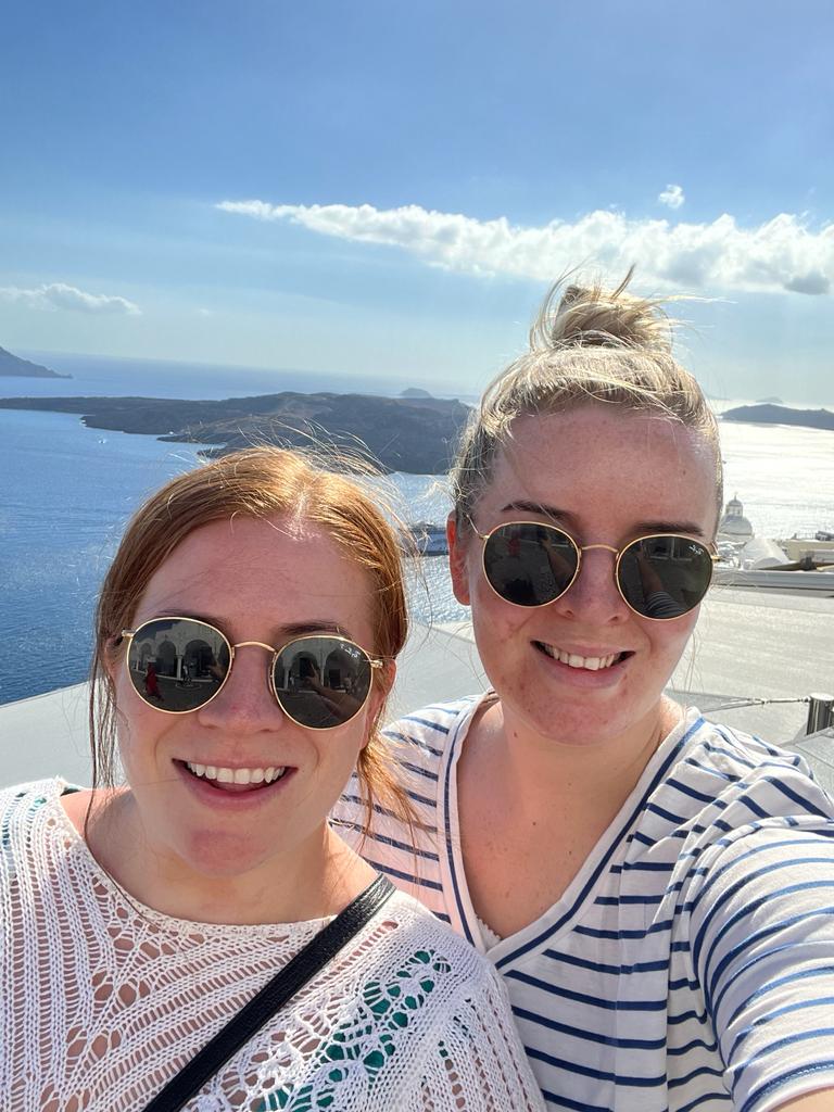 Hayley and Melissa smiling together by the sea
